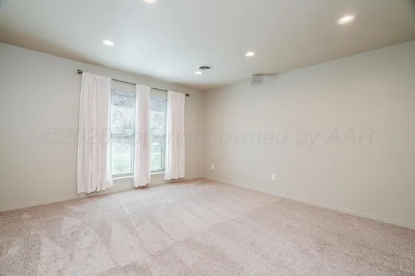 an empty room with a empty space and windows