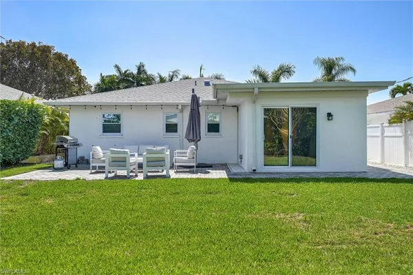 a view of a house with a yard and sitting area