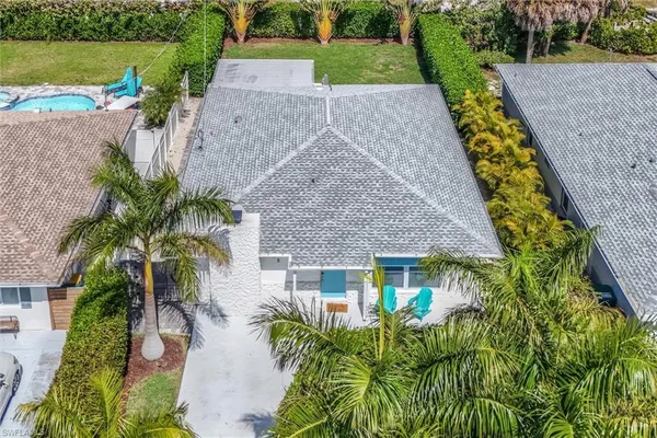 an aerial view of a house with a yard and garden