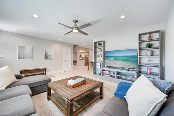a living room with furniture and a flat screen tv
