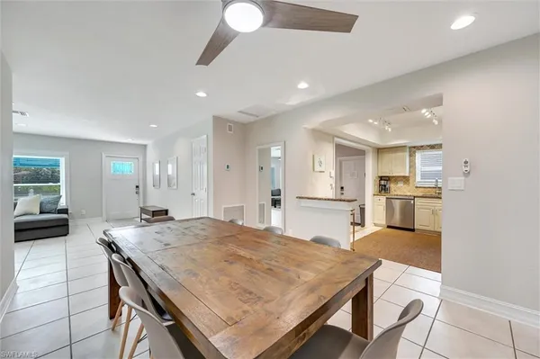 a large kitchen with kitchen island a stove a sink a table and chairs