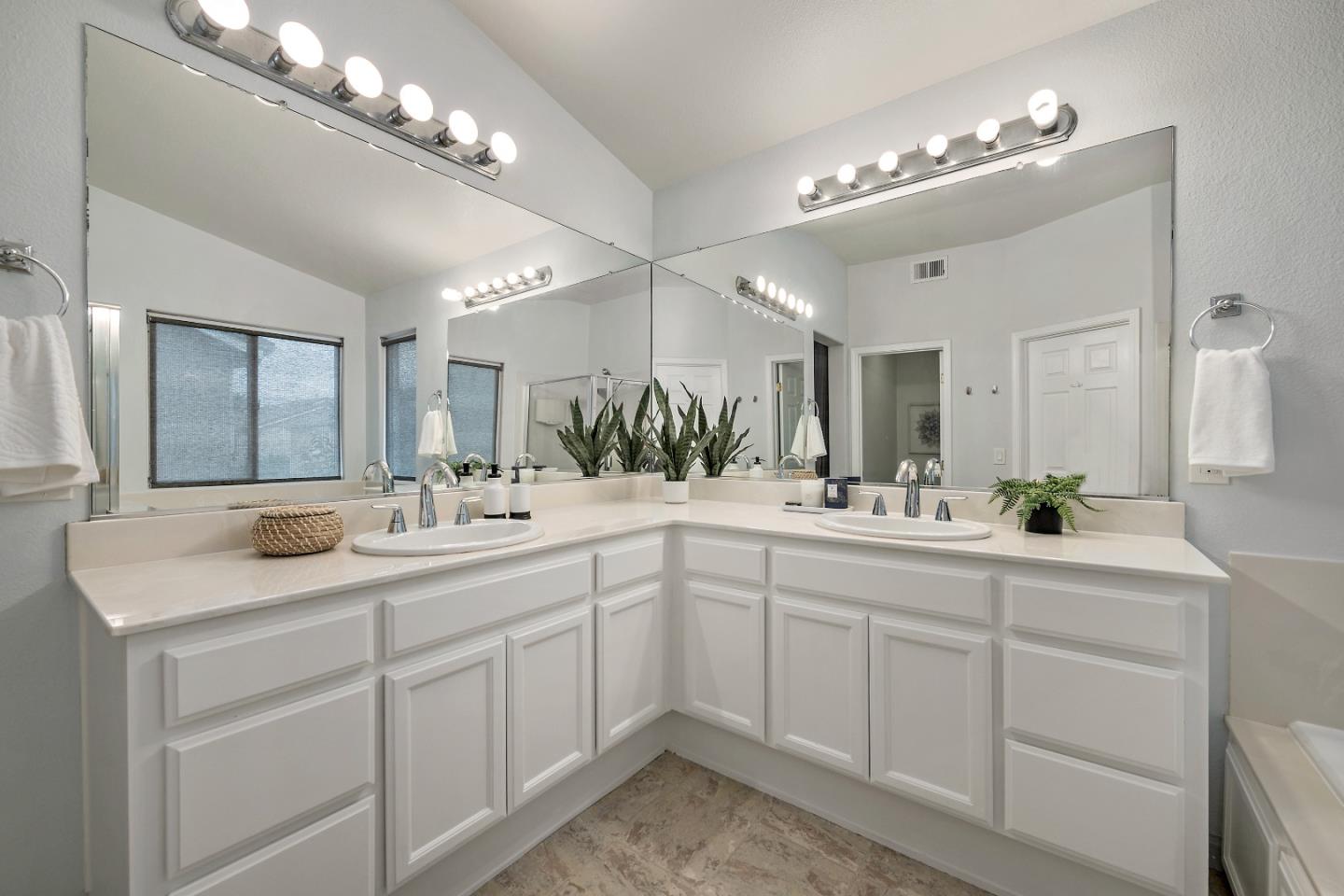8931 Del Rio Circle Gilroy, CA 95020 - Photo 13 of 18 a view with double vanity sink a mirror a lamp a window and a vanity