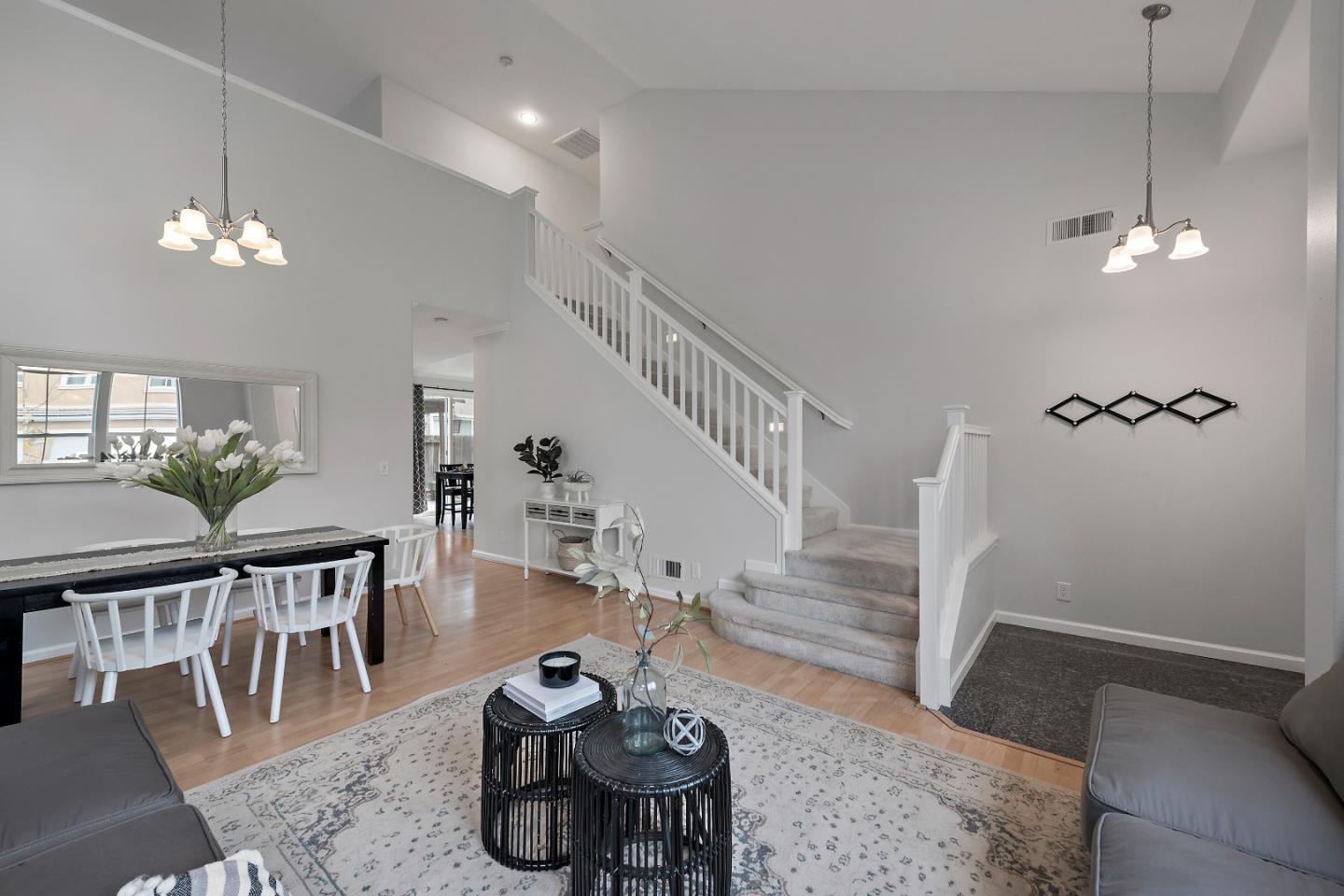 8931 Del Rio Circle Gilroy, CA 95020 - Photo 3 of 18 a living room with furniture a dining table and a chandelier