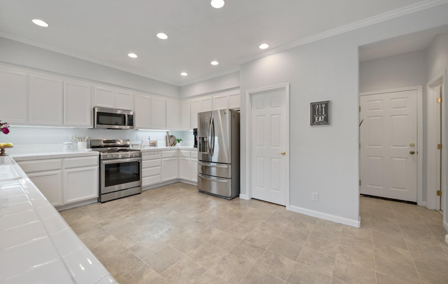 8931 Del Rio Circle Gilroy, CA 95020 - Photo 7 of 18 a kitchen with a refrigerator and a stove top oven