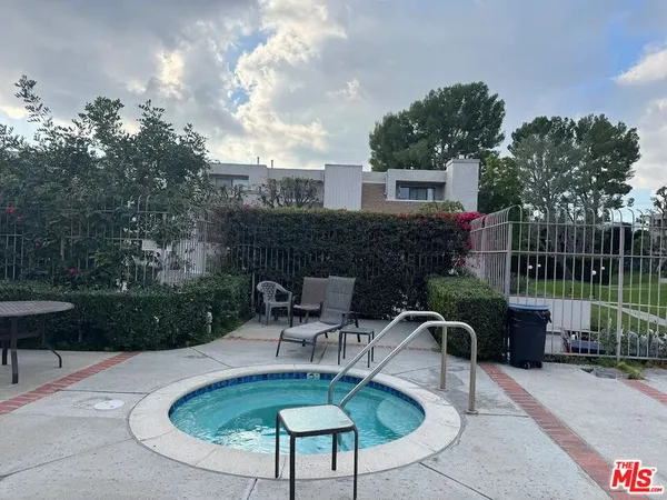 a house view with a seating space and a garden
