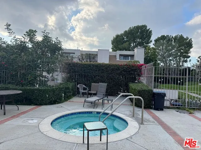 a house view with a seating space and a garden