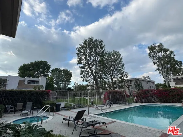 a view of a table and chairs in patio with a yard