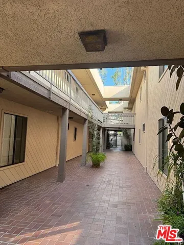 a view of a house with potted plants