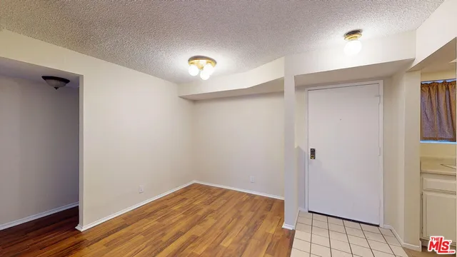 a view of a room with wooden floor and staircase