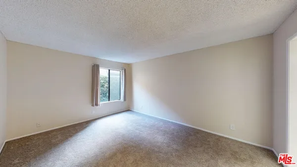 a view of an empty room with windows