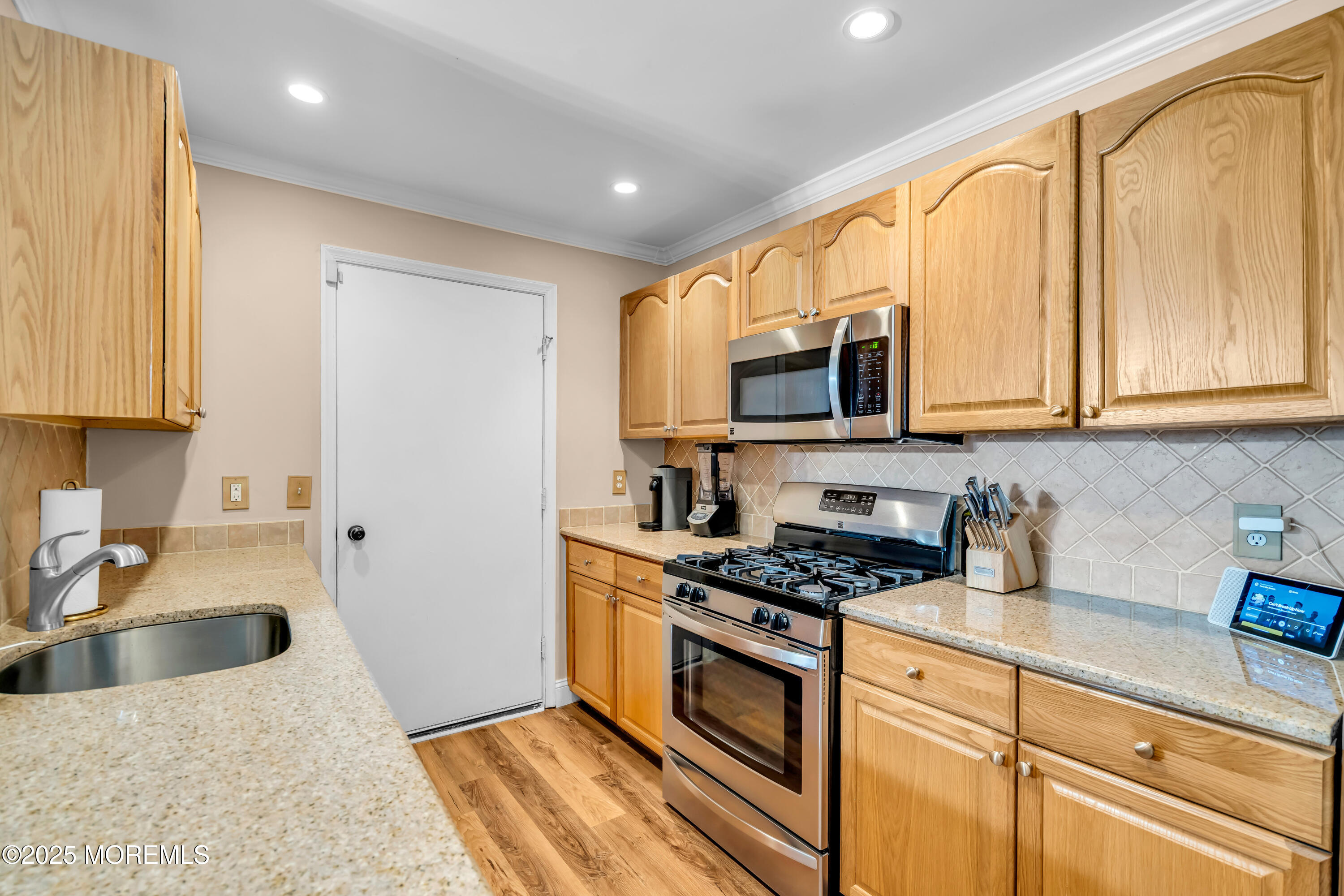 455 Deuce Drive Wall, NJ 07719 - Photo 11 of 26 a kitchen with stainless steel appliances granite countertop a stove a sink and a microwave