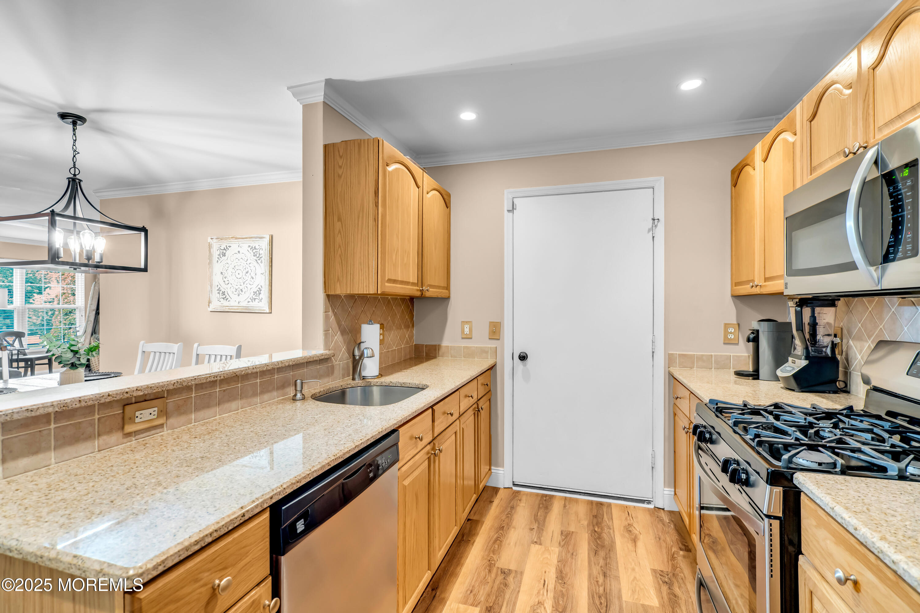 455 Deuce Drive Wall, NJ 07719 - Photo 12 of 26 a kitchen with kitchen island granite countertop a sink cabinets and stainless steel appliances