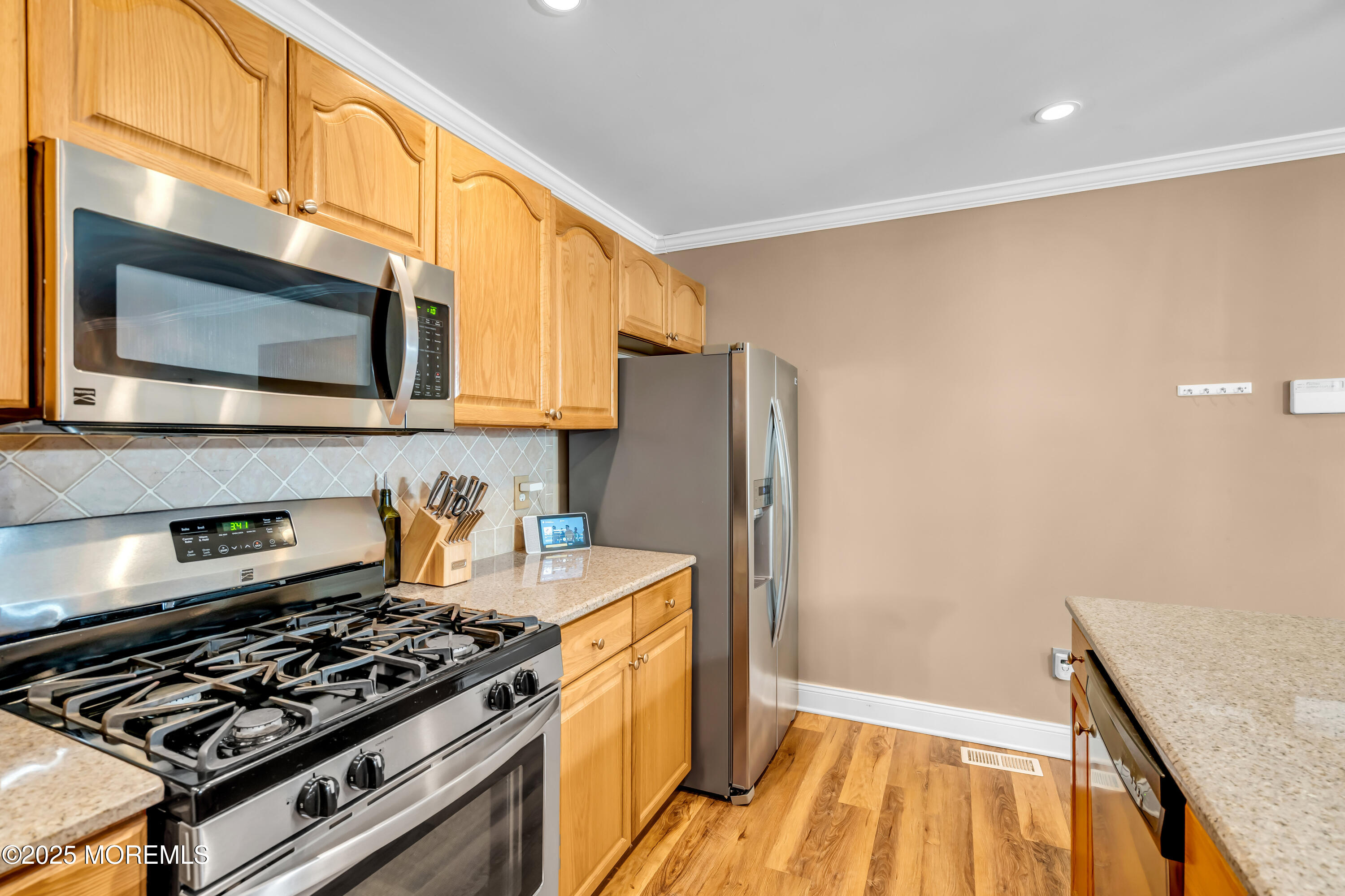 455 Deuce Drive Wall, NJ 07719 - Photo 14 of 26 a kitchen with a stove and a microwave
