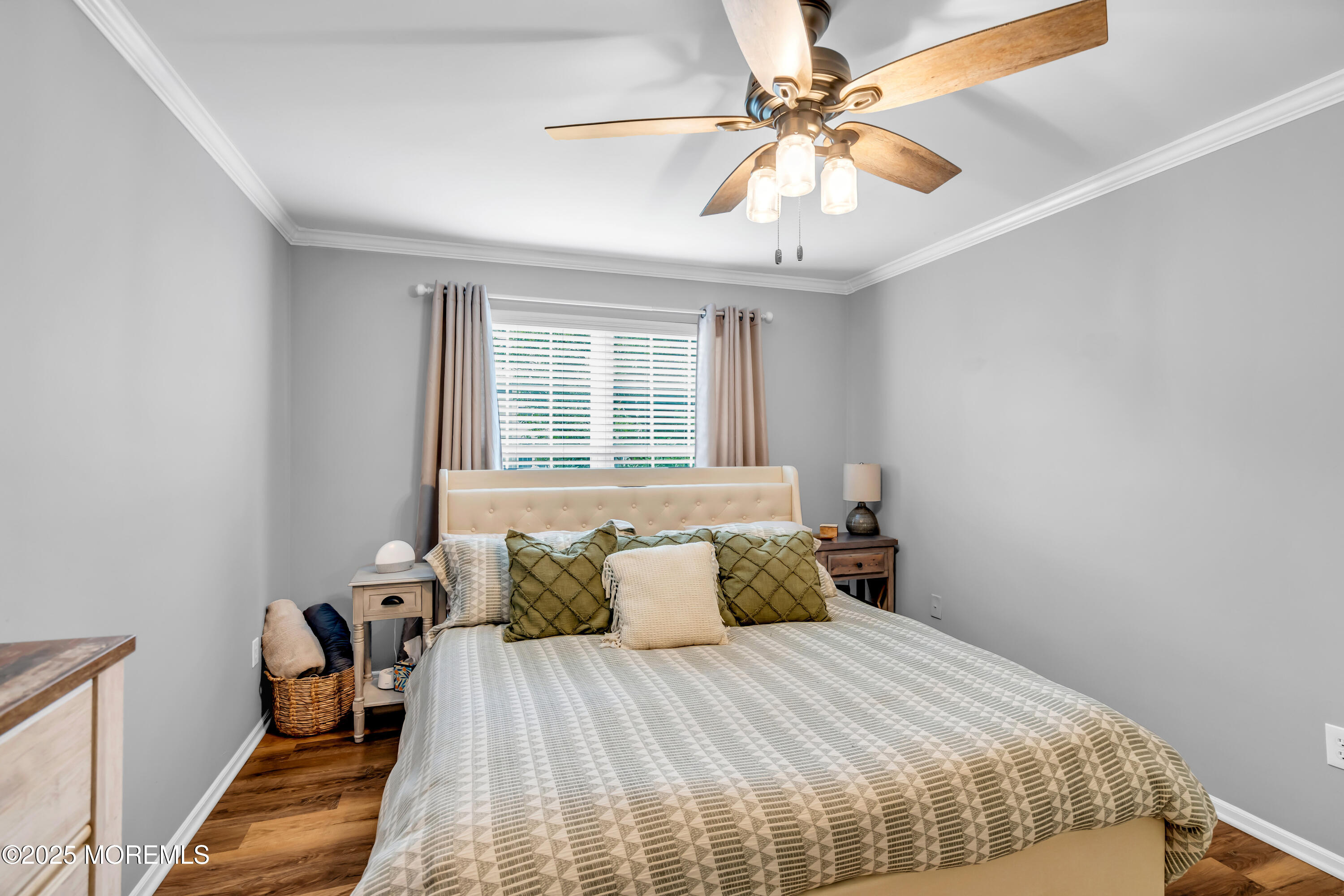 455 Deuce Drive Wall, NJ 07719 - Photo 20 of 26 a bedroom with a bed and a chandelier