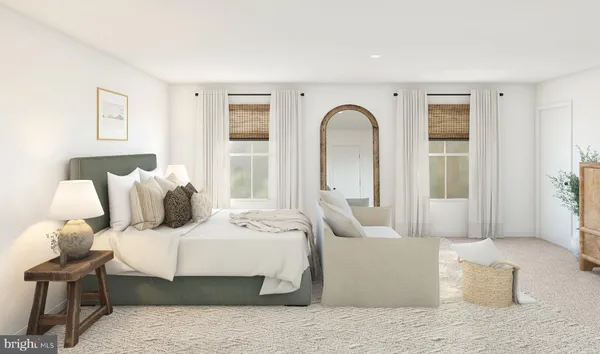 a bedroom with a large bed and a couch