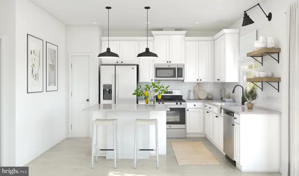 a kitchen with stainless steel appliances kitchen island granite countertop a stove a sink and a refrigerator