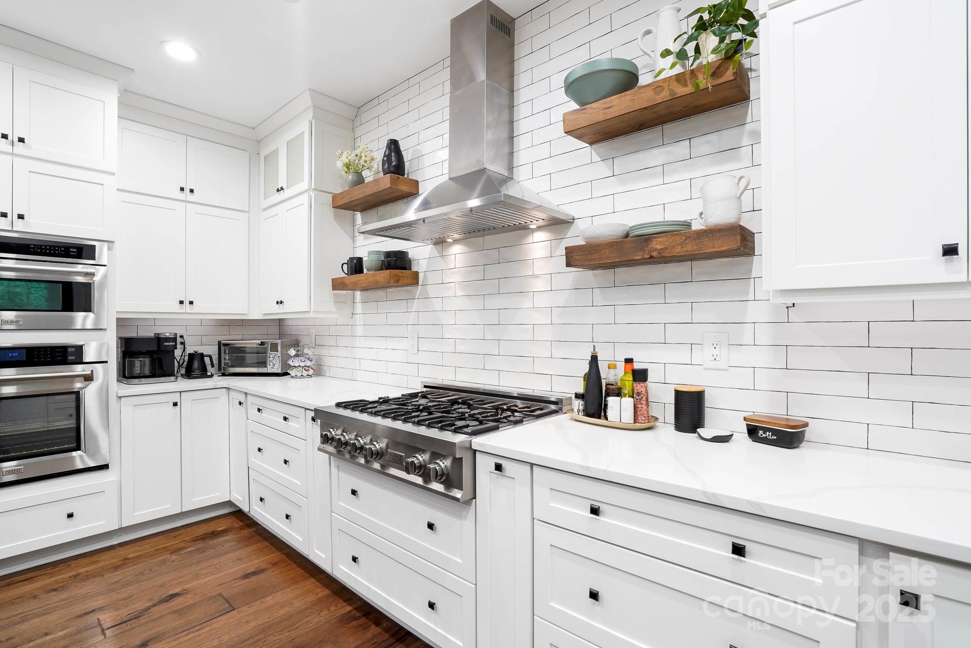 409 Stonewater Bay Mount Holly, NC 28120 - Photo 13 of 47 a kitchen with white cabinets and appliances