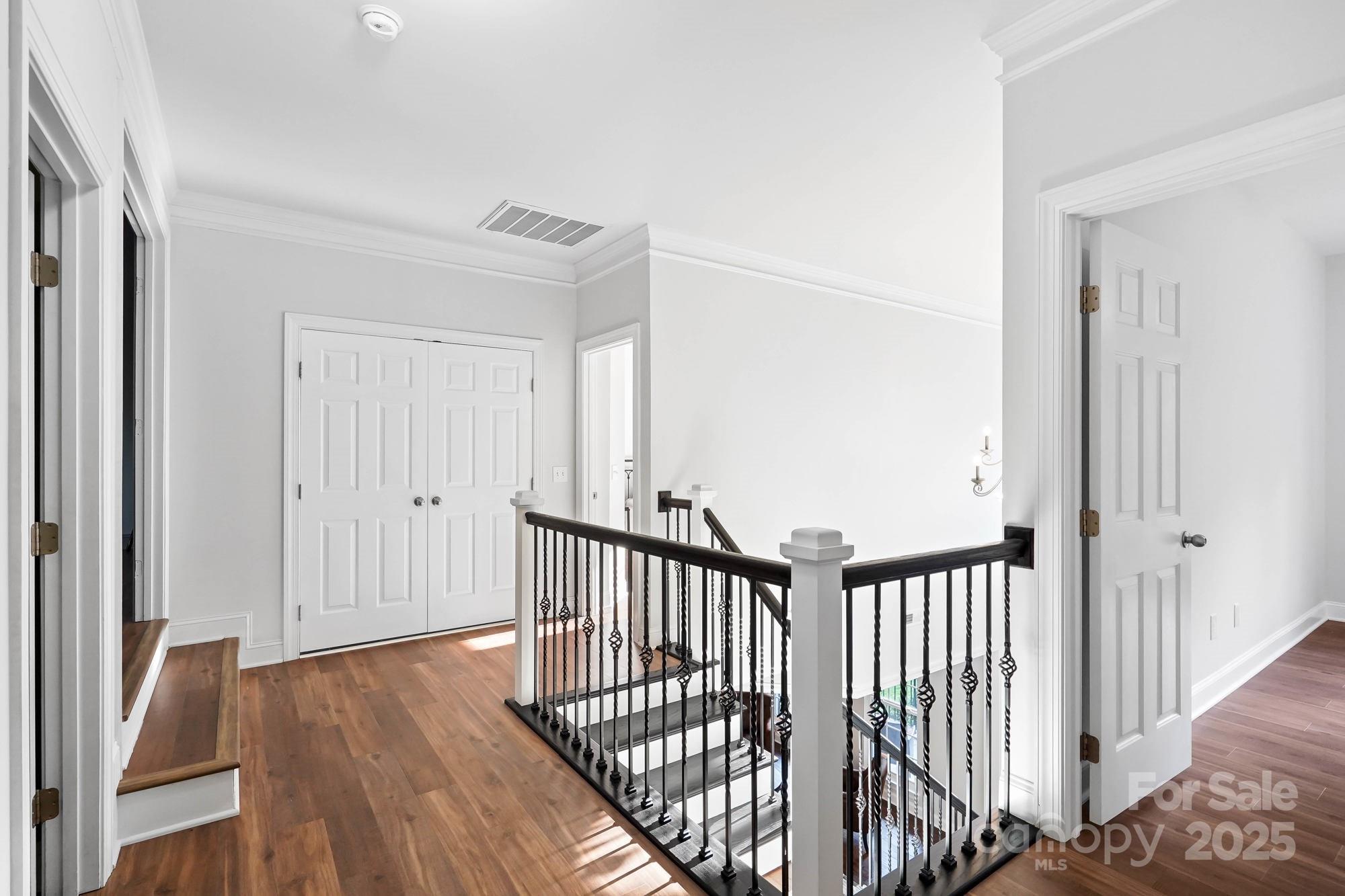 409 Stonewater Bay Mount Holly, NC 28120 - Photo 29 of 47 a view of a hallway with wooden floor and stairs