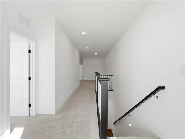 a view of a hallway with a white walls