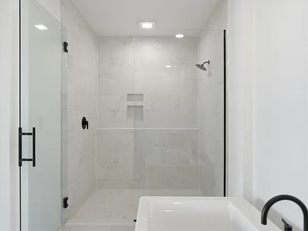 a bathroom with a bathtub and shower