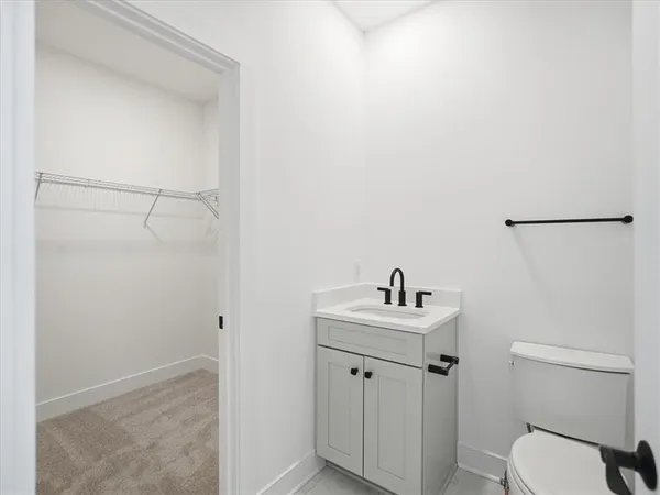 a bathroom with a sink toilet and a mirror