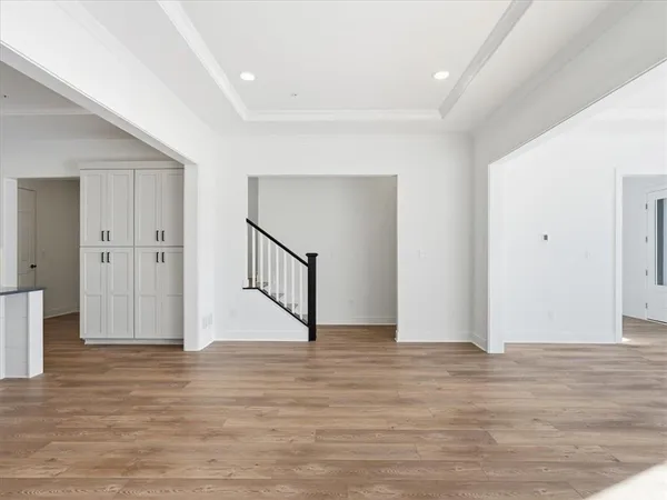 a view of an empty room with wooden floor