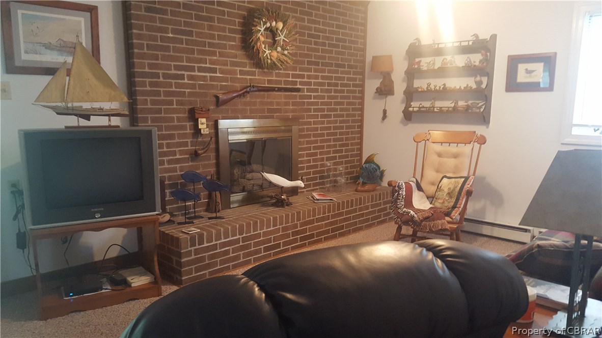 443 Sanders Landing Road North, VA 23128 - Photo 11 of 17 Gas fireplace in living room