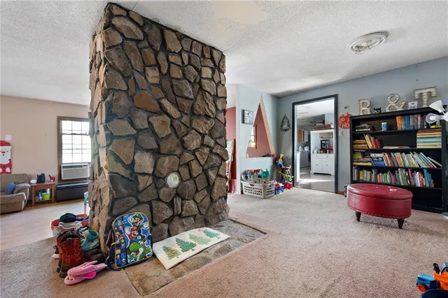 a room with gym equipment and a view of living room