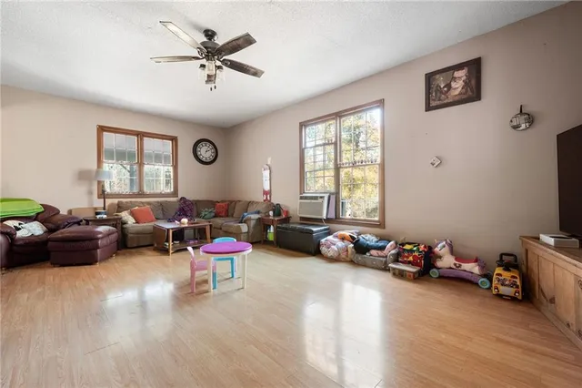 a living room with furniture a fireplace and window