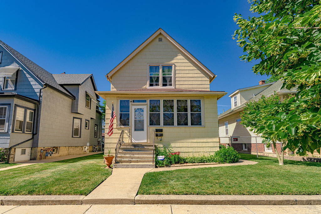 2446 Lewis Street, Unit 2 Blue Island, IL 60406 - Photo 1 of 18 a front view of a house with a yard