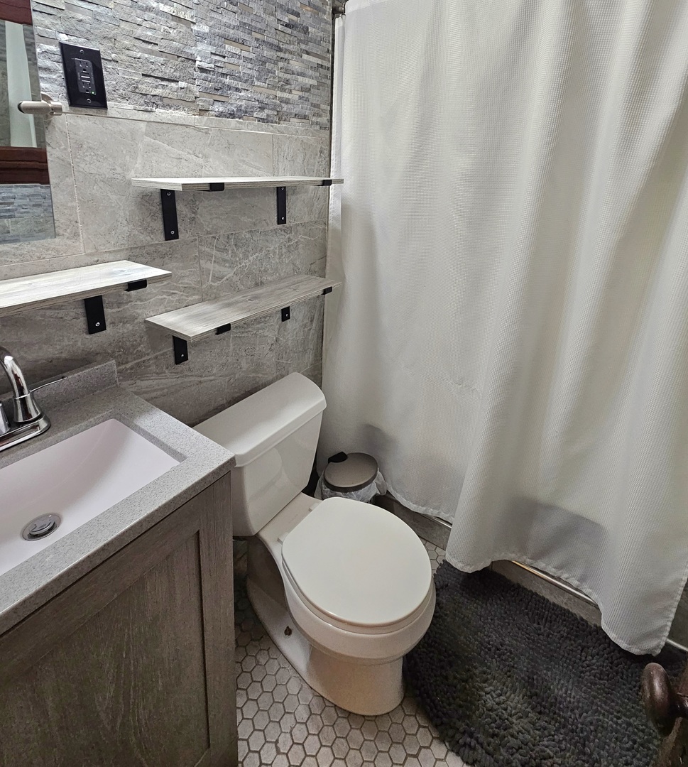 2446 Lewis Street, Unit 2 Blue Island, IL 60406 - Photo 13 of 18 a white toilet sitting next to a bathroom sink