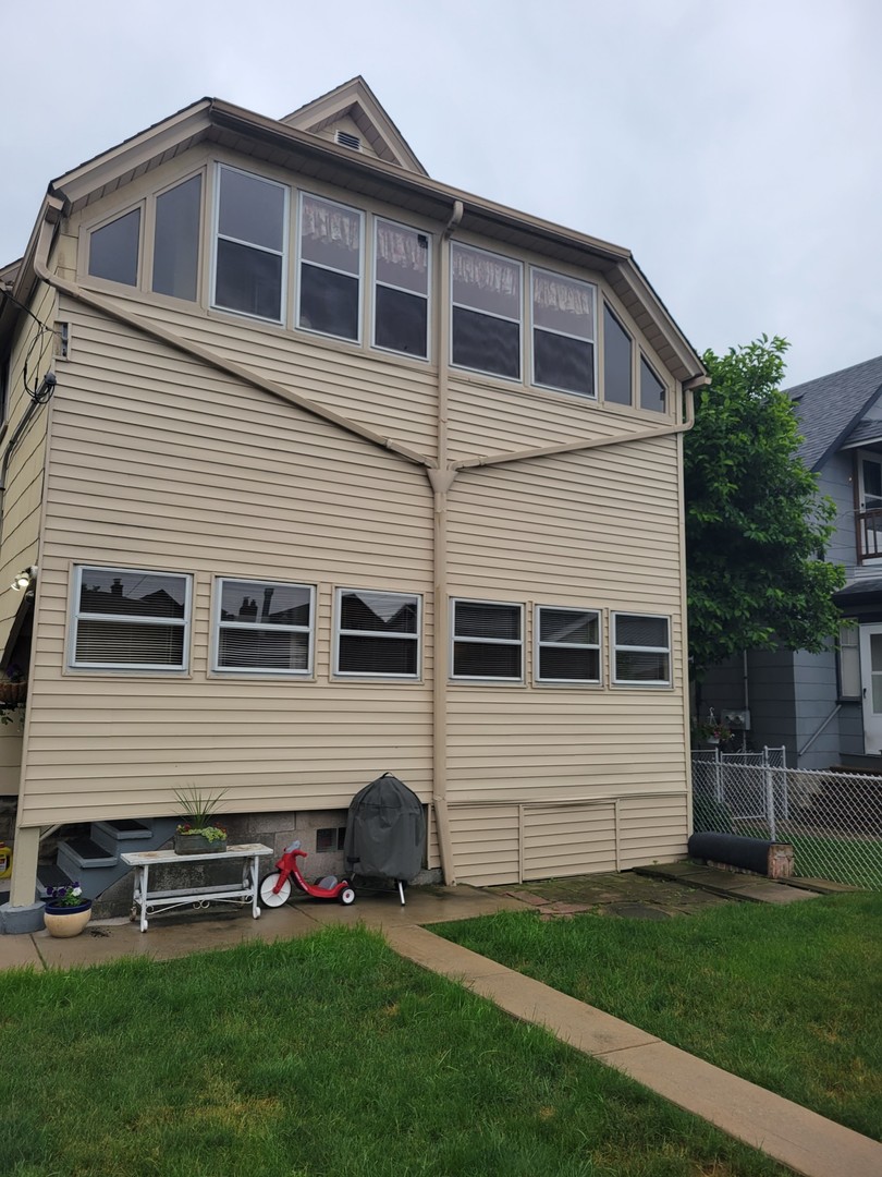 2446 Lewis Street, Unit 2 Blue Island, IL 60406 - Photo 16 of 18 a front view of a house with a garden