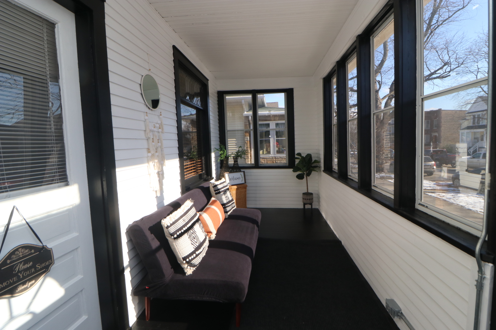 2446 Lewis Street, Unit 2 Blue Island, IL 60406 - Photo 2 of 18 a view of a balcony with couch and wooden floor