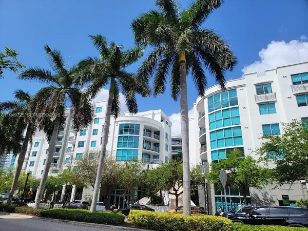 a view of multiple houses with palm trees