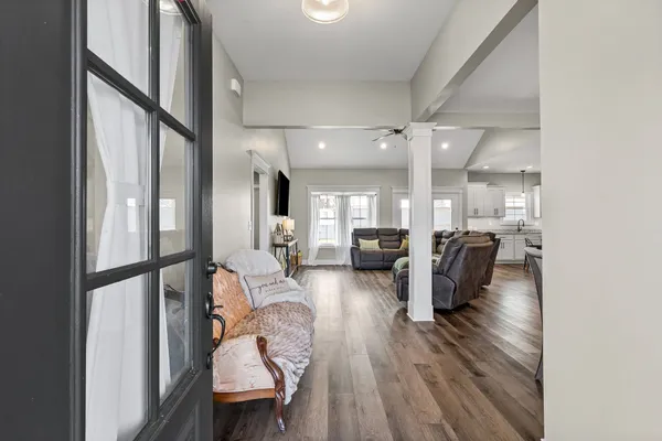 a living room with furniture and a wooden floor