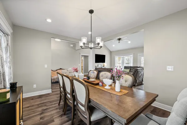 a view of a dining room with furniture wooden floor and chandelier