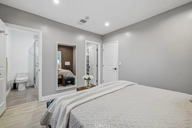 a bedroom with a large bed and a couch