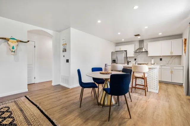 a view of a dining room with furniture and wooden floor
