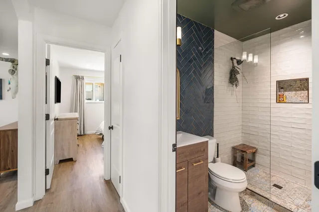 a bathroom with a toilet and a shower