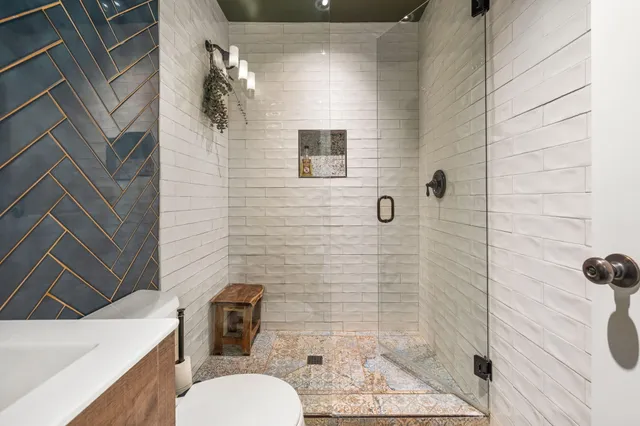 a bathroom with a toilet and shower