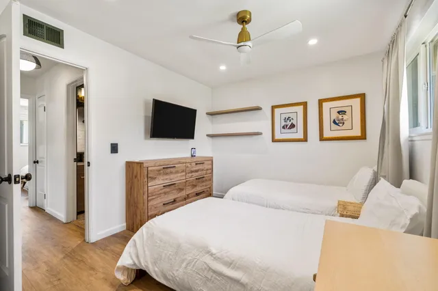 a bedroom with a bed and a flat screen tv