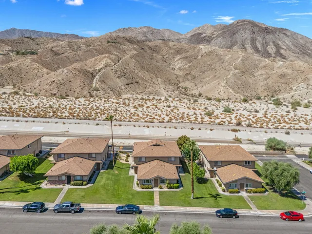 an aerial view of residential houses with outdoor space