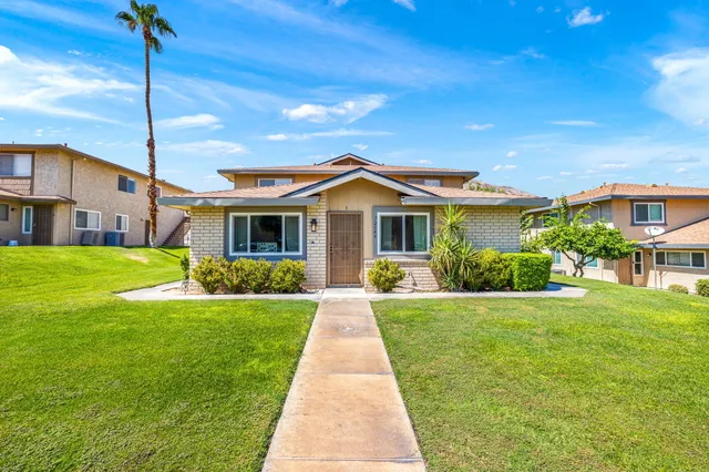 a front view of house with yard and green space