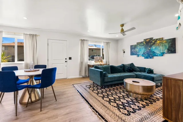 a living room with furniture a rug and a window