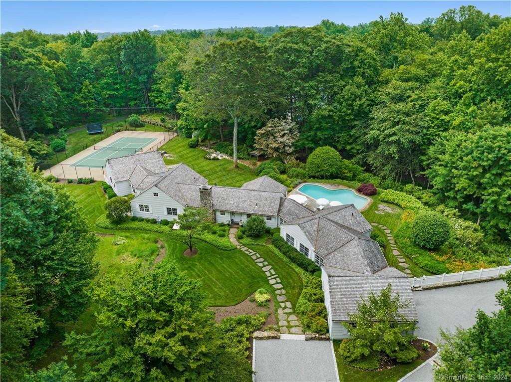 an aerial view of green landscape with trees houses and mountain view