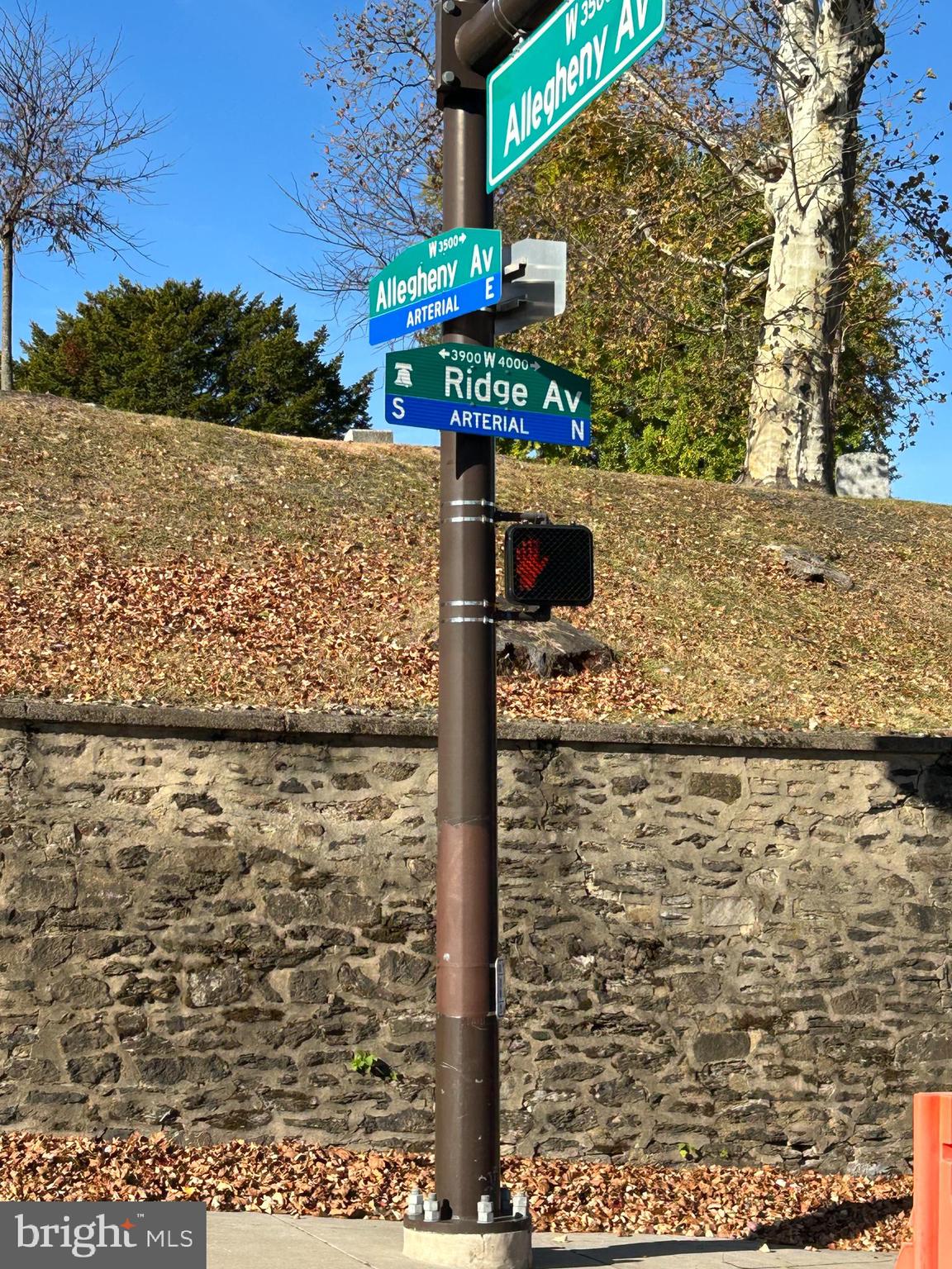 a street sign on a wall next to a road