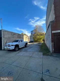 a view of a car parked in back yard of a building