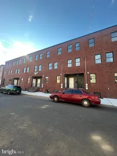 a front view of a building with parking space