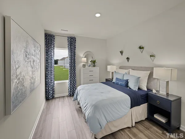 a spacious bedroom with a bed and a view of bedroom