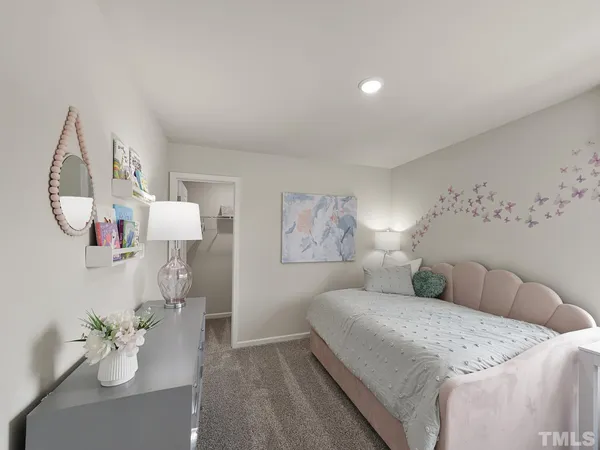 a spacious bedroom with a bed and a chandelier